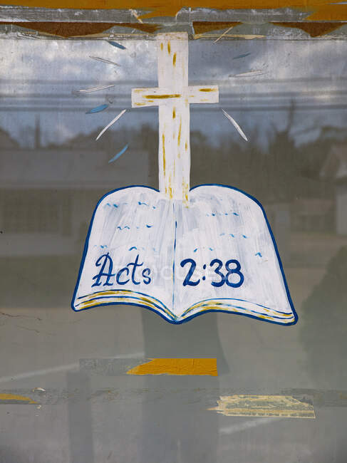 Hand painted bible and cross, a religious sign on a glass window. — Stock Photo