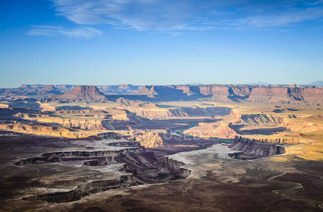 Views across the canyons of the Canyonland National Park at sunset, sandstone ridges and cliffs and the Colorado River. — Stock Photo