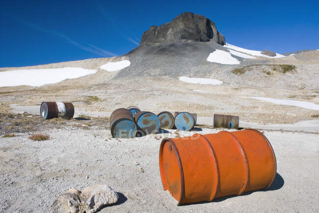 Fuel drums abandoned by miners and left to rust and leak into the wilderness watershed of Salal Creek, — Stock Photo