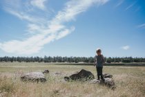 Little boy walking in field — Stock Photo