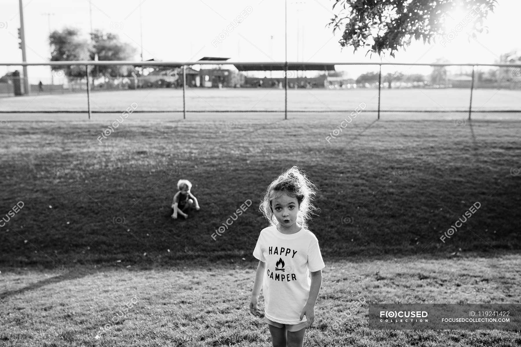 girl-playing-with-her-friend-at-the-playground-place-little-stock