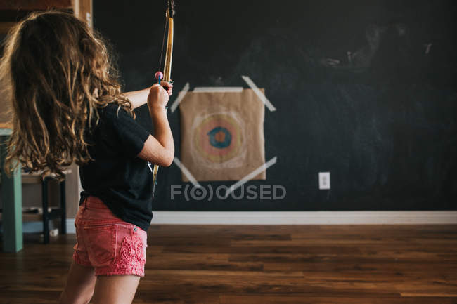 Little archer aims at a target — Stock Photo