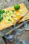 Glasses and cutted limes — Stock Photo