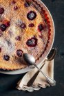 Cheesecake with berries on black table — Stock Photo