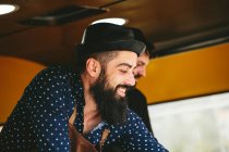 Cooks hipsters selling food — Stock Photo
