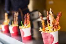 Grilled meat on sticks with fries — Stock Photo