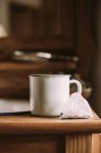 Old tea cup on wooden table — Stock Photo