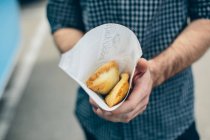 Paper bag with baked patties — Stock Photo