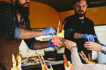 Cooks hipsters selling food — Stock Photo