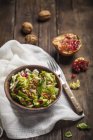 Salad with walnuts and pomegranate seeds — Stock Photo