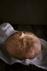 Loaf of bread on white cloth — Stock Photo