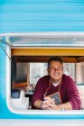Mature cook in food truck — Stock Photo
