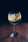 Gin tonic cocktail with lemon zest — Stock Photo