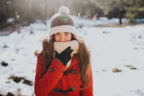 Smiling brunette girl in snowy forest — Stock Photo