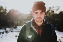 Young backpacker in winter forest — Stock Photo