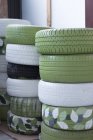 Stacks of car tyres in garage — Stock Photo