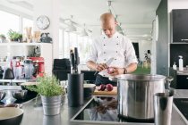 Chef taglio cipolle in cucina — Foto stock