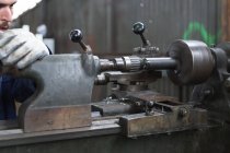 Craftsman working with iron lathe — Stock Photo