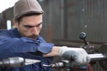 Man working with iron details — Stock Photo