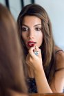 Woman applying lipstick — Stock Photo