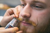 Barber arranging moustache — Stock Photo