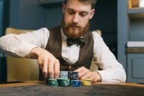Poker player with chips — Stock Photo