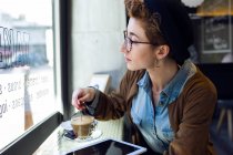 Young beautiful woman in cafe — Stock Photo