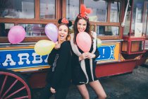 Young girls with balloons — Stock Photo
