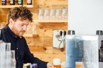 Man holding glass with froth beer — Stock Photo