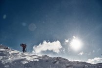 Climber on top of snowy mountain — Stock Photo