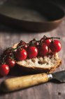 Still life with branch of cherry tomatoes — Stock Photo