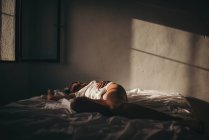 Sensual woman lying on bed — Stock Photo