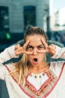 Young blonde girl grimaces — Stock Photo