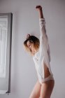 Young woman stretching at home — Stock Photo