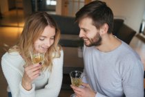 Pair talking and holding wine glasses — Stock Photo