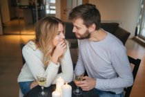 Pair talking and holding wine glasses — Stock Photo