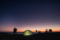 Couple with tent and bicycle on nature — Stock Photo
