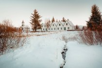 Houses in snowy plain — Stock Photo