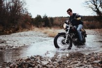 Motorcyclist riding in rocks — Stock Photo