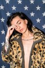 Young tattooed brunette in leopard coat — Stock Photo