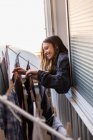 Smiling woman hanging out laundry — Stock Photo