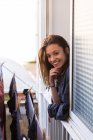 Cheerful girl looking out of window — Stock Photo