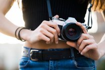 Hands of woman setting camera — Stock Photo