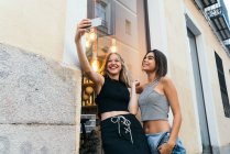 Young girlfriends taking selfie — Stock Photo
