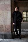 Stylish man standing in black — Stock Photo