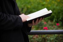 Человек, читающий книгу снаружи — стоковое фото