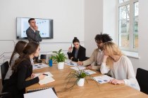 Group of young colleagues working with diagrams while meeting — Stock Photo
