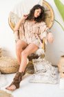 Young girl in rattan chair — Stock Photo