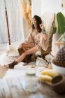 Young woman in rattan chair — Stock Photo