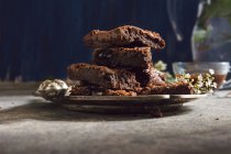 Pile of brownie bars on metal plate — Stock Photo